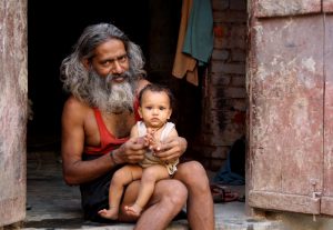 Man holding a Baby in Varanasi
